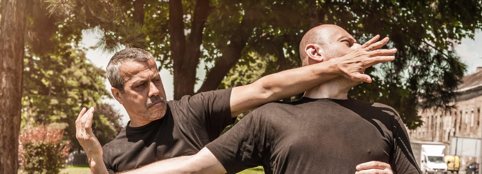 Two men practicing a self-defense palm strike outdoors